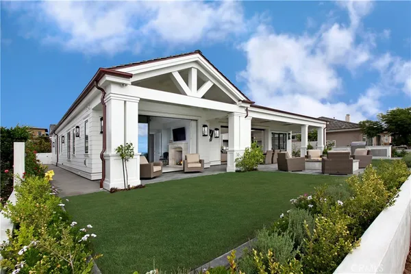 a front view of house with yard and outdoor seating