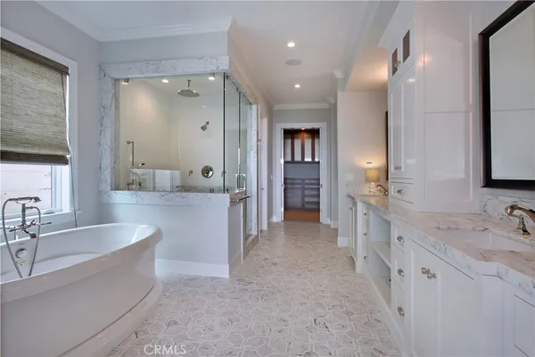 a bathroom with double sink and three mirror