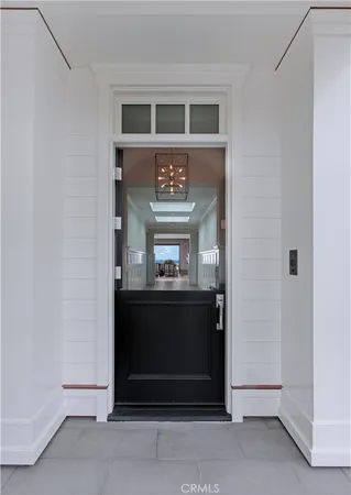 a room with lots of wooden furniture a chandelier and wooden floor