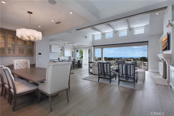a open kitchen with stainless steel appliances granite countertop a table chairs sink and cabinets