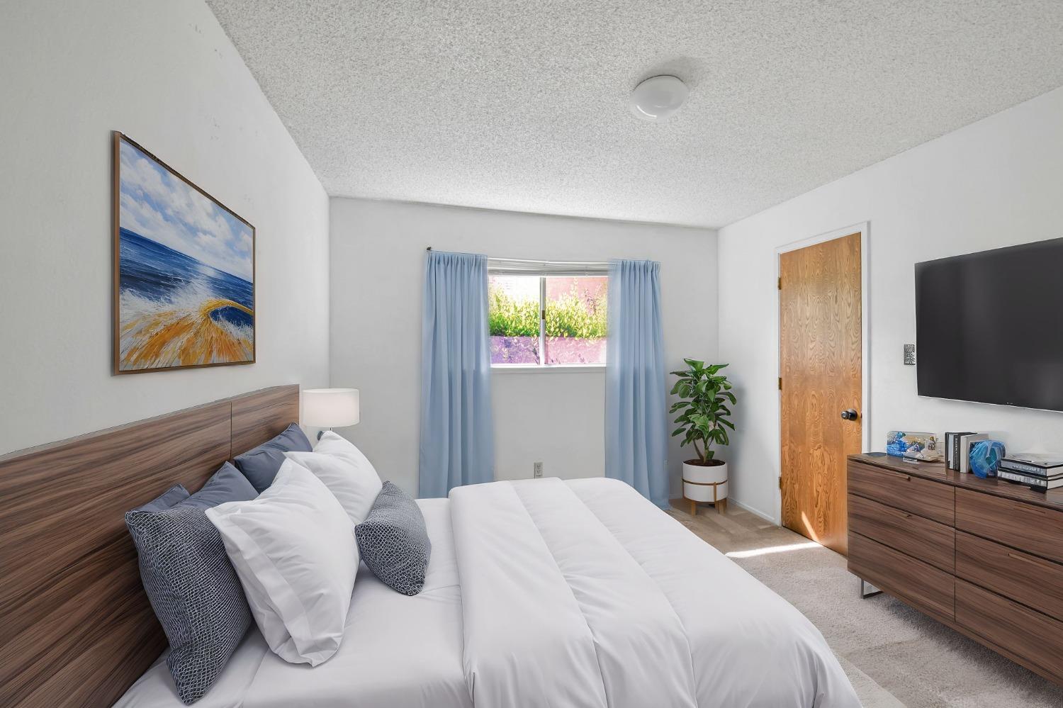 7822 Tamara Drive Fair Oaks, CA 95628 - Photo 28 of 28 a bedroom with a bed and a flat screen tv