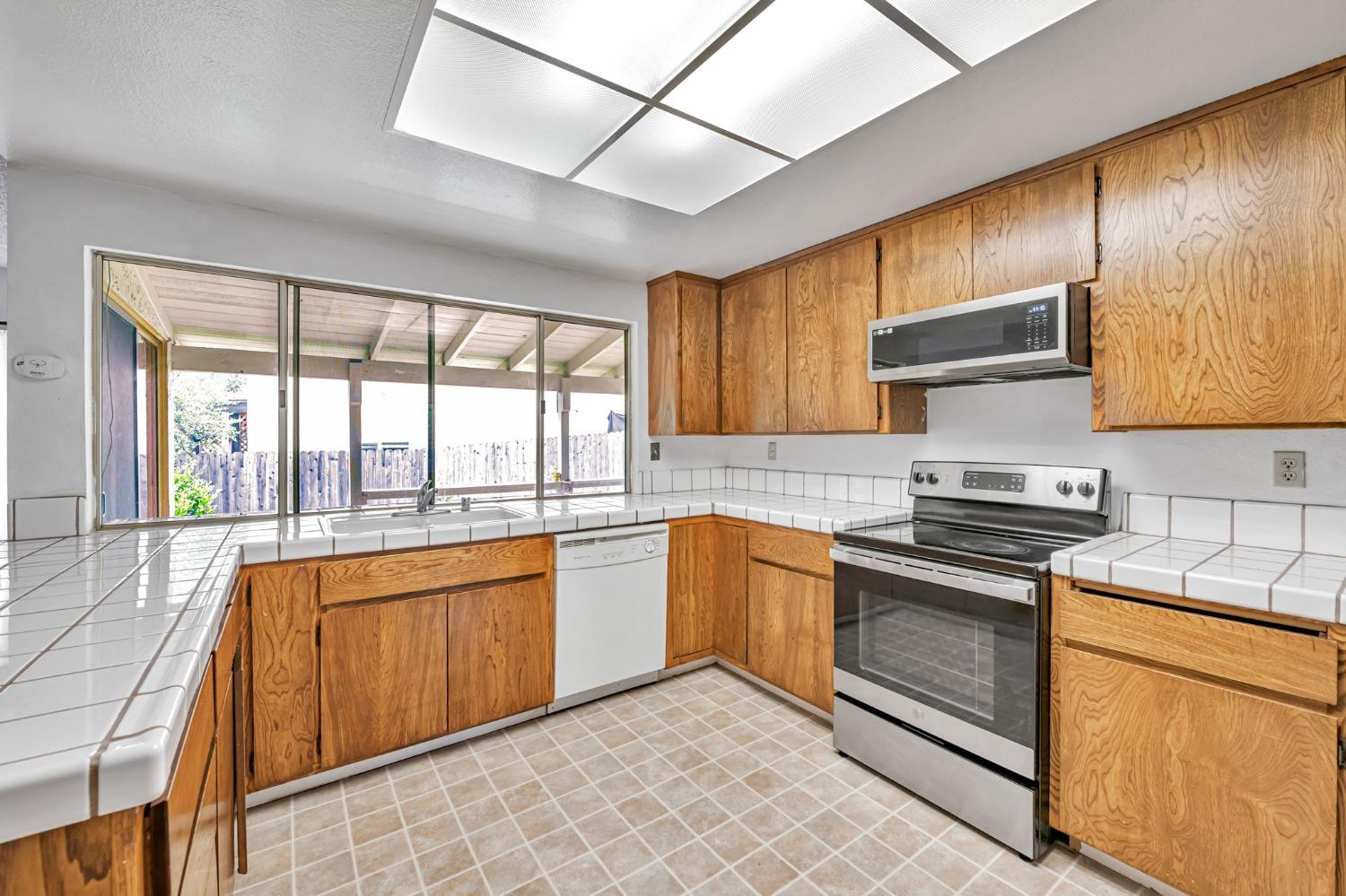7822 Tamara Drive Fair Oaks, CA 95628 - Photo 3 of 28 a kitchen with stainless steel appliances granite countertop a stove sink and cabinets