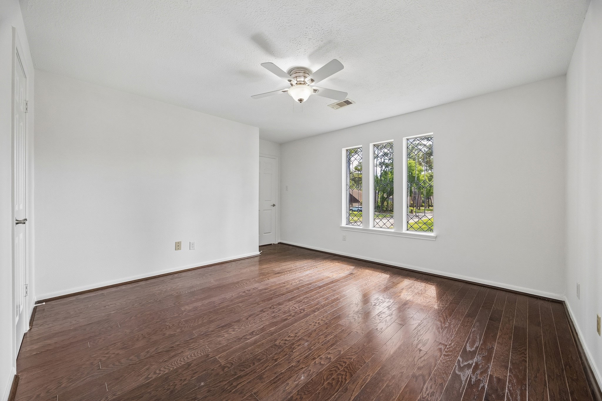 9718 Oxted Lane Spring, TX 77379 - Photo 26 of 38 All three secondary bedrooms are well-sized with large windows, generously sized closets, and hardwood floors