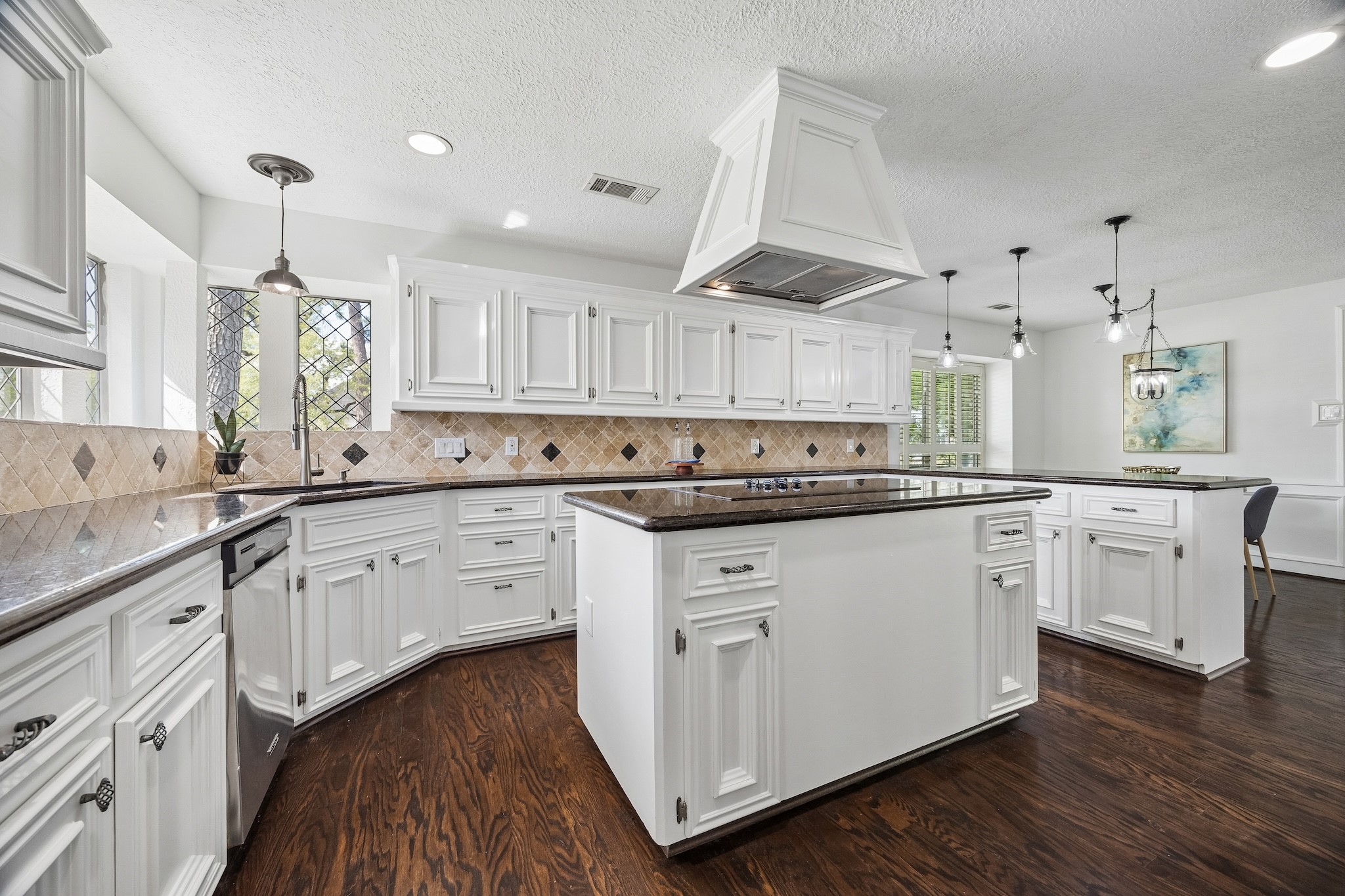 9718 Oxted Lane Spring, TX 77379 - Photo 8 of 38 The white island kitchen has granite coutnertops and stainless steel appliances
