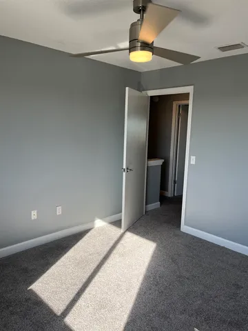 a white toilet sitting next to a shower
