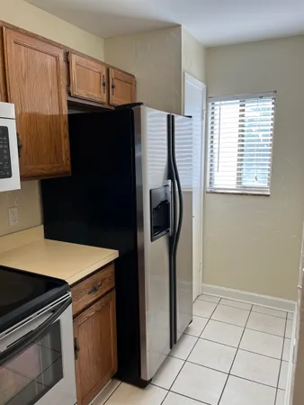 a kitchen with a refrigerator stove and microwave