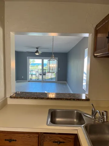 a view of a chairs and table in the balcony
