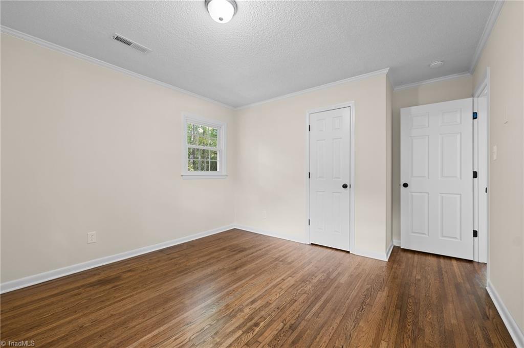 403 Snider Street High Point, NC 27265 - Photo 10 of 23 Primary bedroom. New lighting and refinished hardwood floors.
