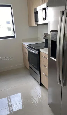 a kitchen with stainless steel appliances a refrigerator and a stove