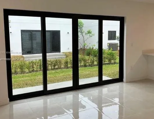 a view of an empty room with large windows