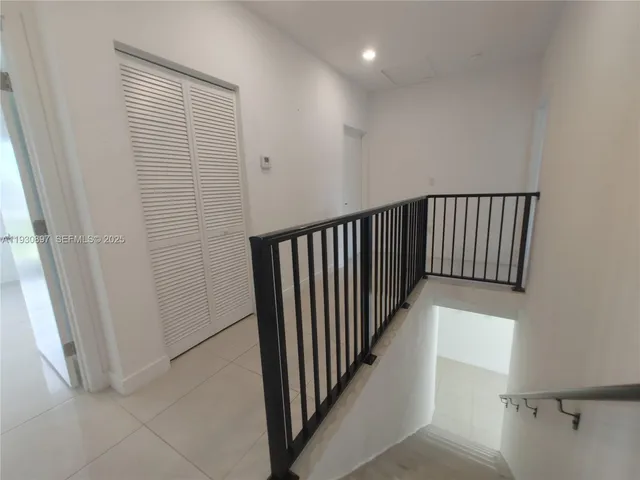 a view of a hallway with entryway door