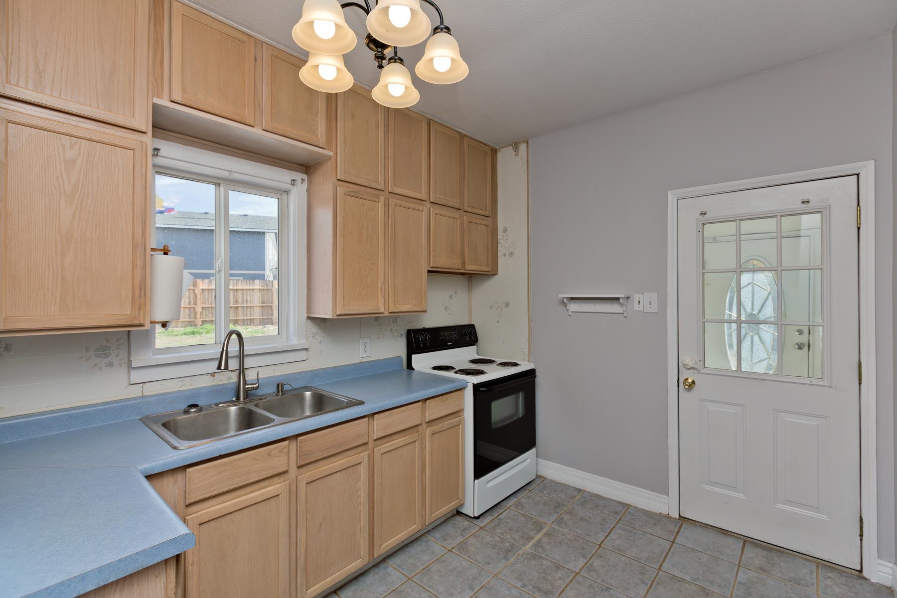 431 Pleasant Ridge Lane, Unit B Grand Junction, CO 81507 - Photo 14 of 20 a kitchen that has a sink cabinets and window