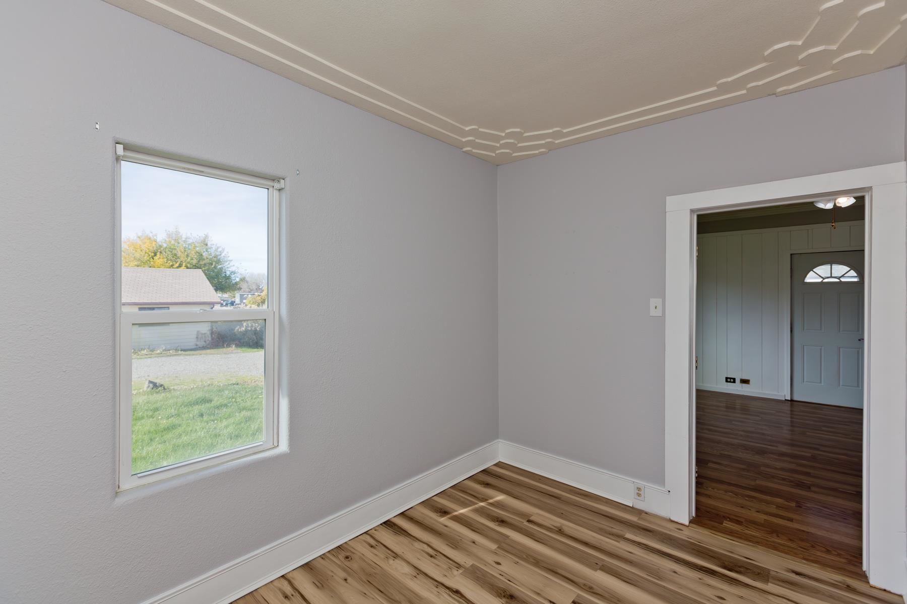 431 Pleasant Ridge Lane, Unit B Grand Junction, CO 81507 - Photo 19 of 20 a view of an empty room with wooden floor and a window
