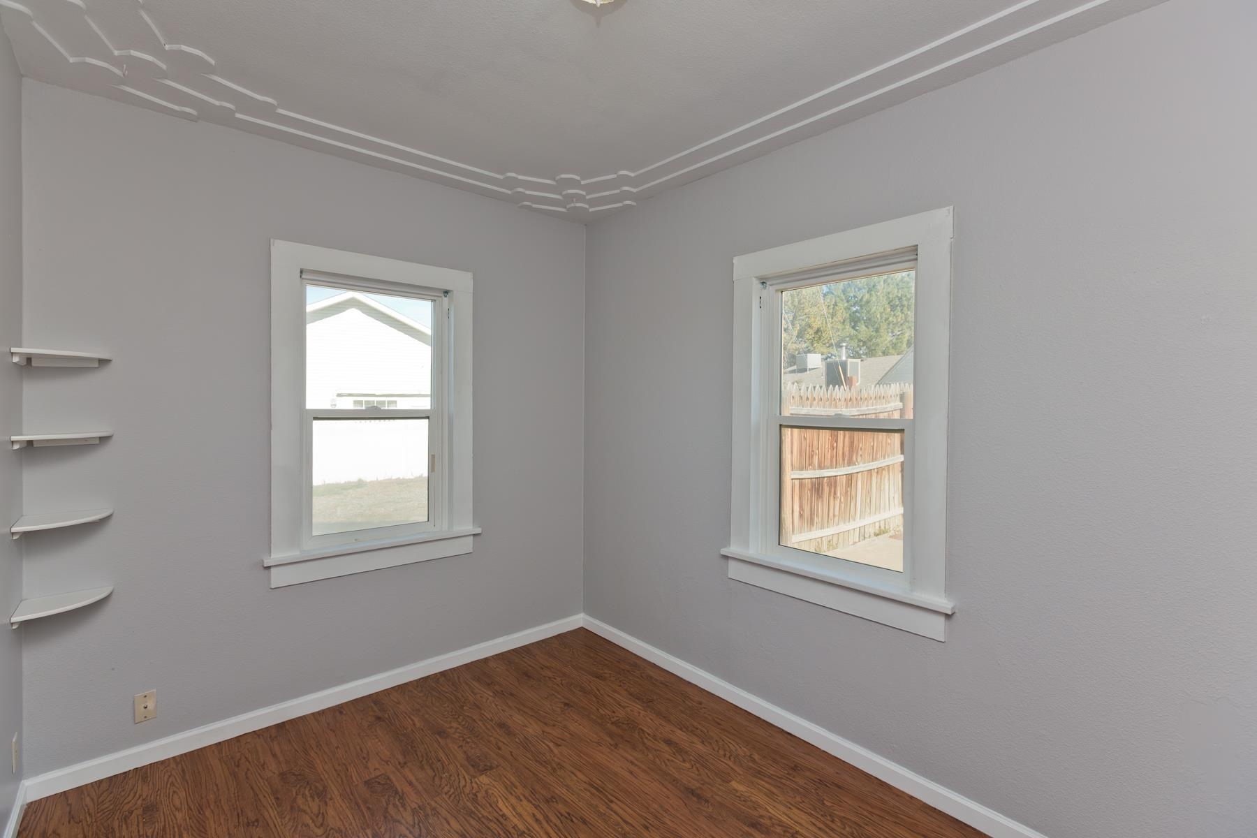 431 Pleasant Ridge Lane, Unit B Grand Junction, CO 81507 - Photo 20 of 20 a view of an empty room with wooden floor and a window