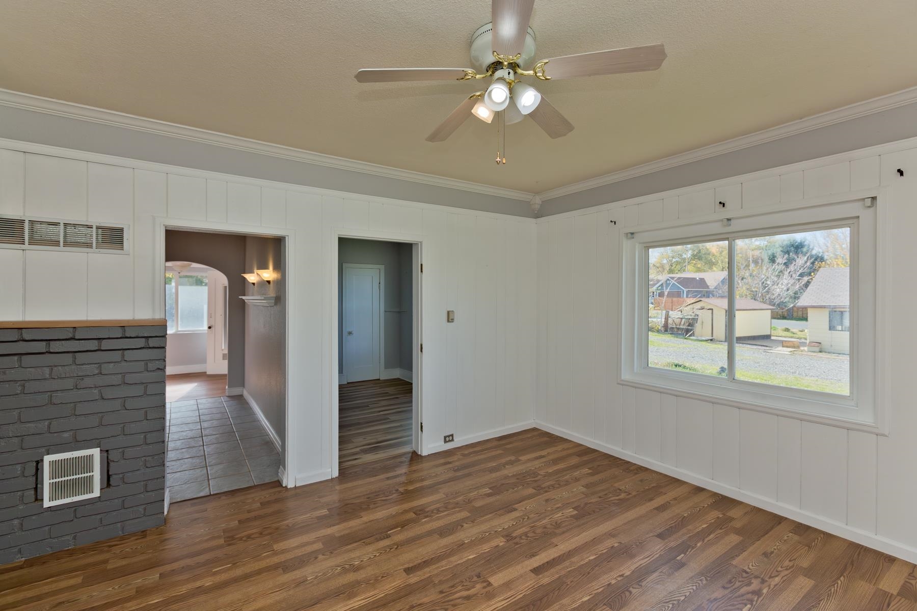 431 Pleasant Ridge Lane, Unit B Grand Junction, CO 81507 - Photo 8 of 20 a view of an empty room with wooden floor and a window