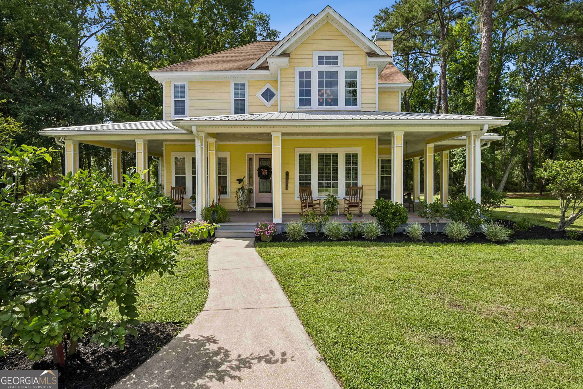 706 Hopewell Point Road White Oak, GA 31568 - Photo 1 of 84 A welcoming front approach leads to a spacious wraparound porch designed for relaxing, entertaining, and enjoying the peaceful surroundings.