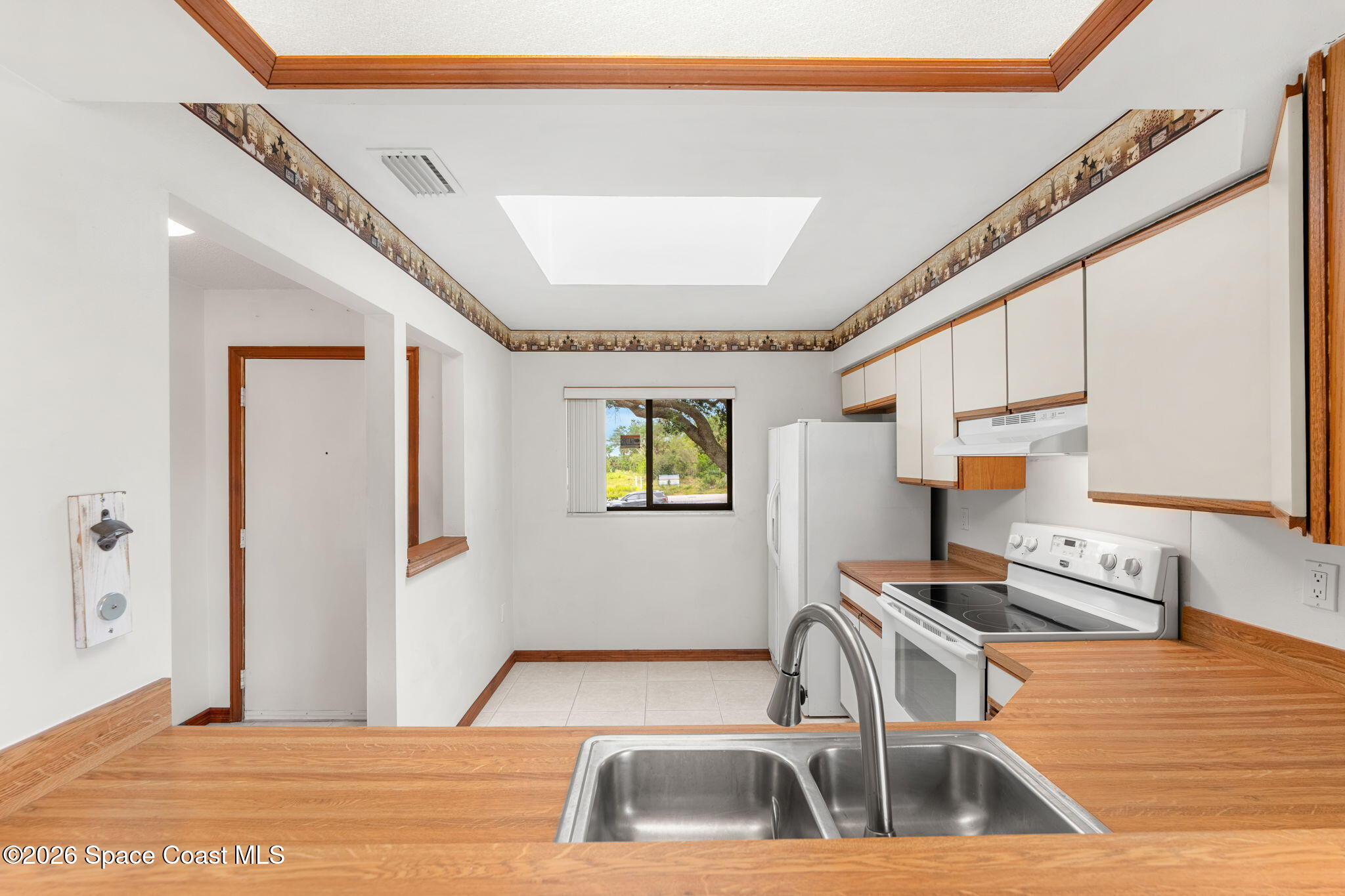 3121 Kirkland Road Northeast Palm Bay, FL 32905 - Photo 10 of 52 a kitchen with a sink cabinets and a counter top space