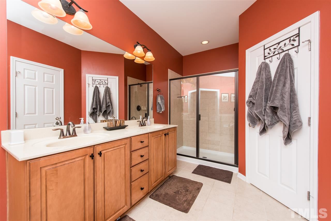 924 Chapanoke Road Raleigh, NC 27603 - Photo 11 of 20 a bathroom with a double vanity sink mirror and shower