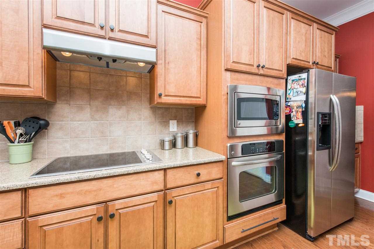 924 Chapanoke Road Raleigh, NC 27603 - Photo 7 of 20 a kitchen with stainless steel appliances granite countertop a refrigerator sink and stove