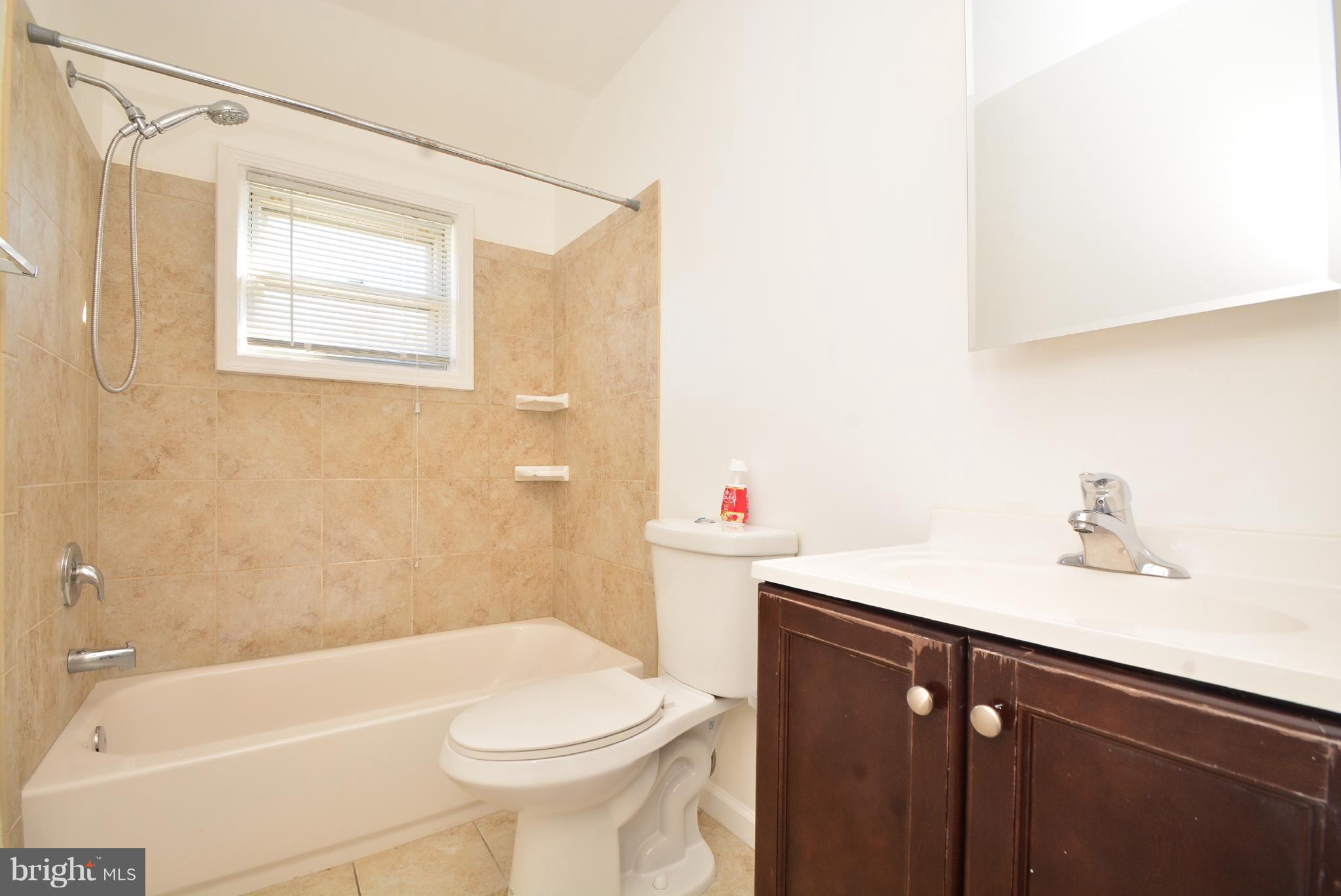 1947 Quentin Road Baltimore, MD 21222 - Photo 14 of 20 a bathroom with a sink a toilet and shower