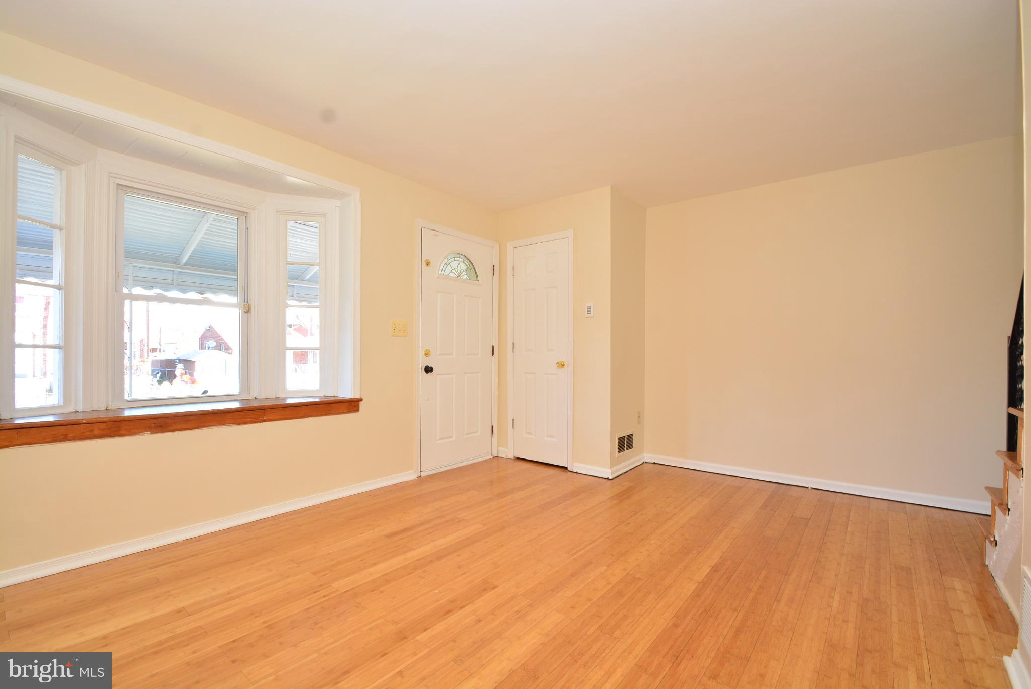 1947 Quentin Road Baltimore, MD 21222 - Photo 4 of 20 a view of empty room with wooden floor and fan