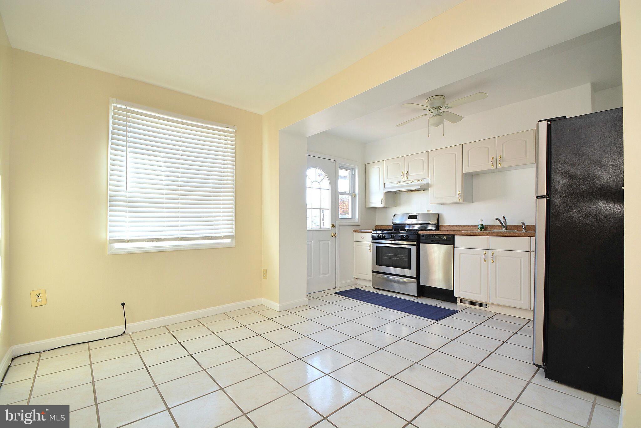 1947 Quentin Road Baltimore, MD 21222 - Photo 7 of 20 a kitchen with a stove a sink and a refrigerator