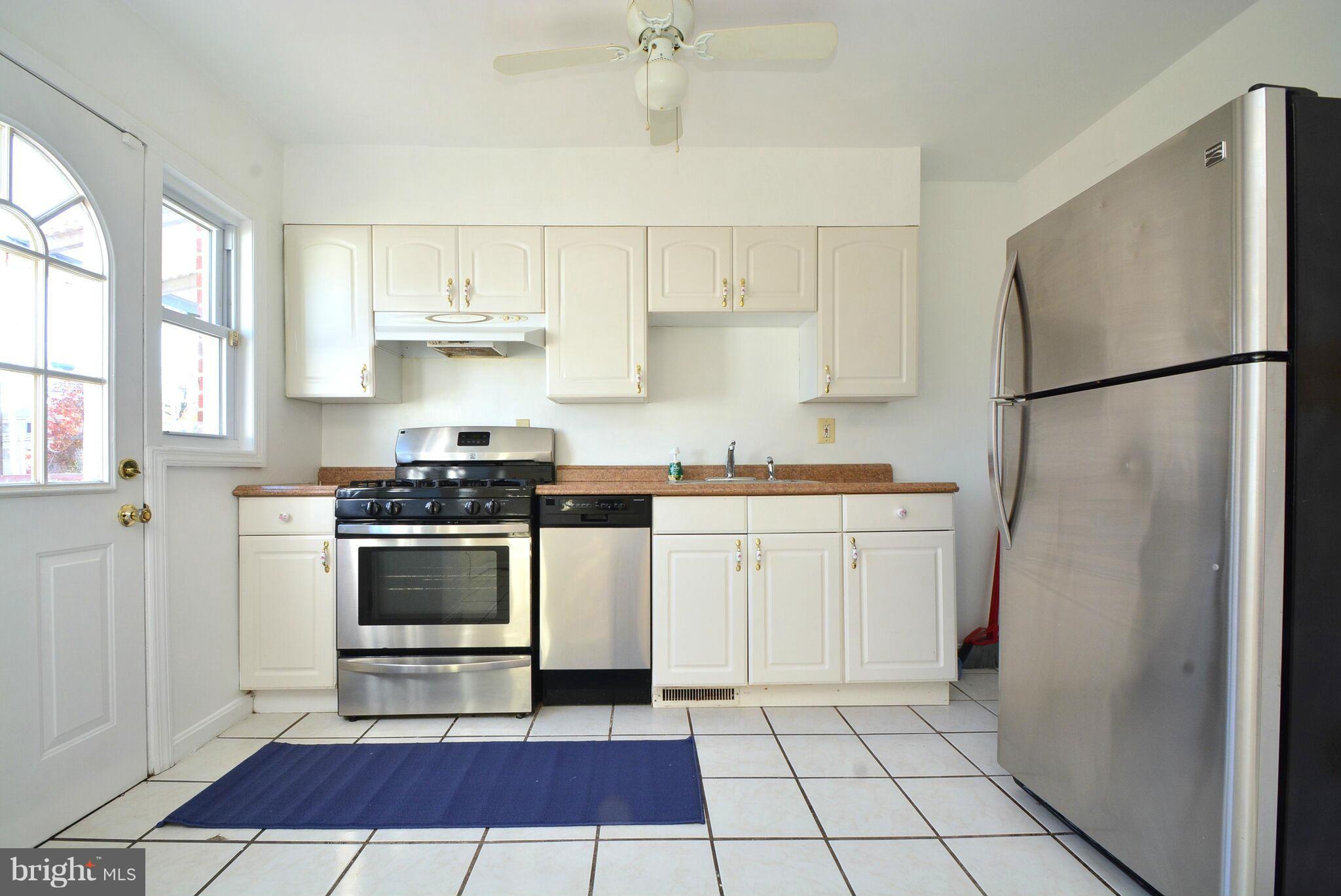 1947 Quentin Road Baltimore, MD 21222 - Photo 8 of 20 a kitchen with a refrigerator and a stove
