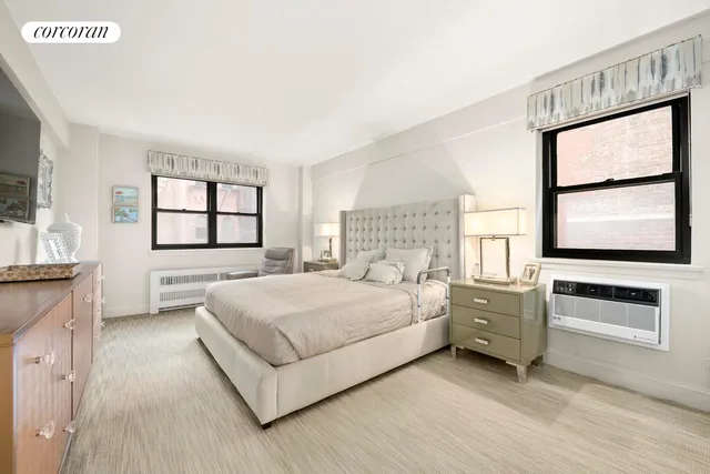 a bedroom with a bed and a large window