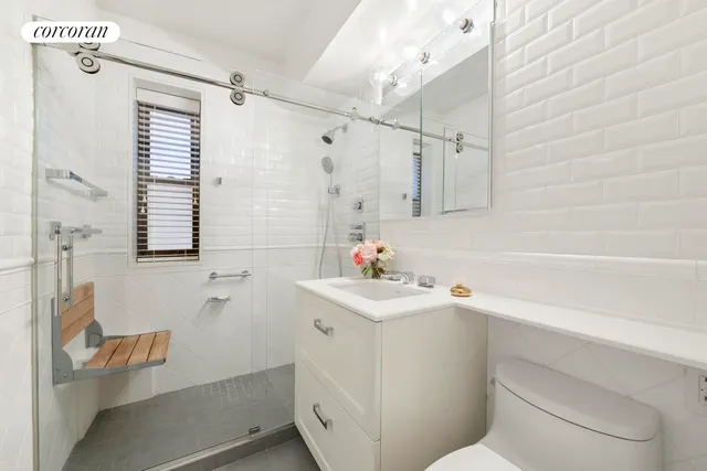 a bathroom with a sink toilet vanity and tub