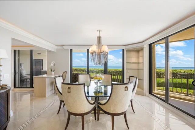 a view of a dining room with furniture large windows and wooden floor