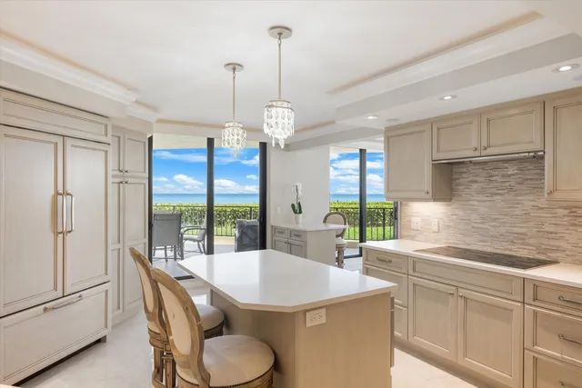a kitchen with a table chairs refrigerator and sink