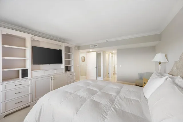 a bedroom with a flat screen television and a bed