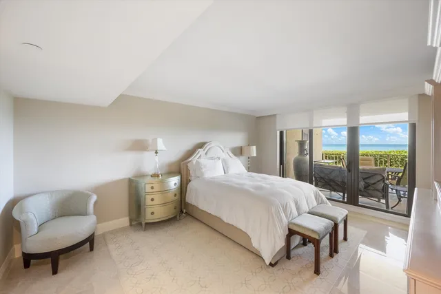 a bedroom with a bed and a chair