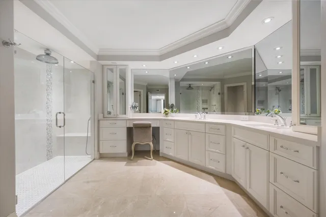 a spacious bathroom with a shower a sink and mirror