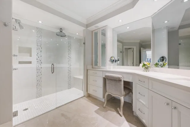 a spacious bathroom with a shower a sink and a large mirror