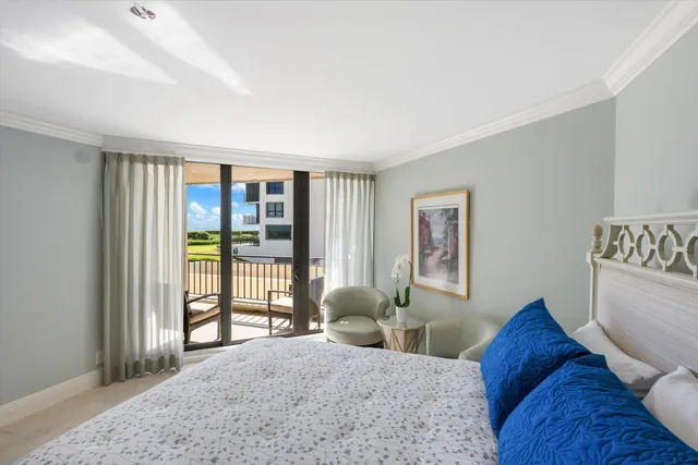 a bedroom with a bed and glass window