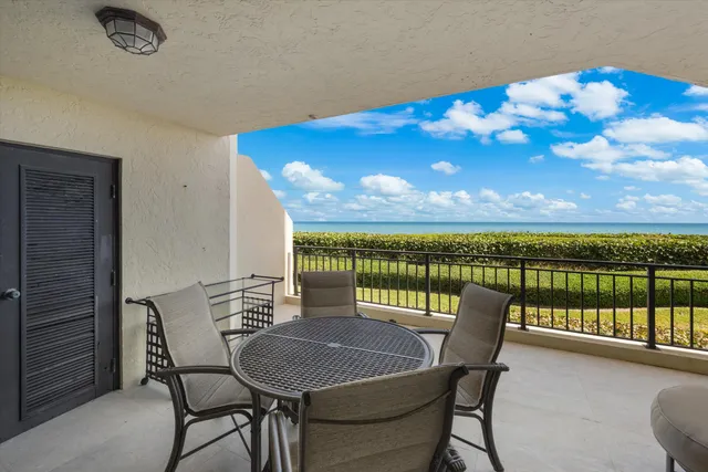 a view of a balcony with a table and chairs