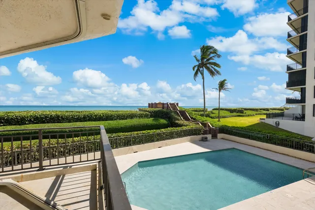 a view of a back yard with a wooden fence