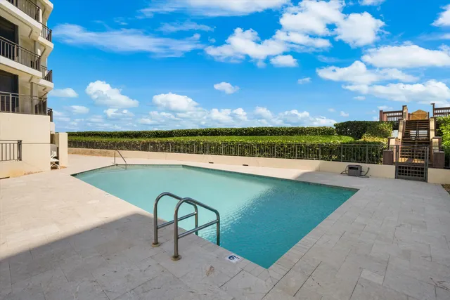 a view of swimming pool with outdoor seating and a lake view