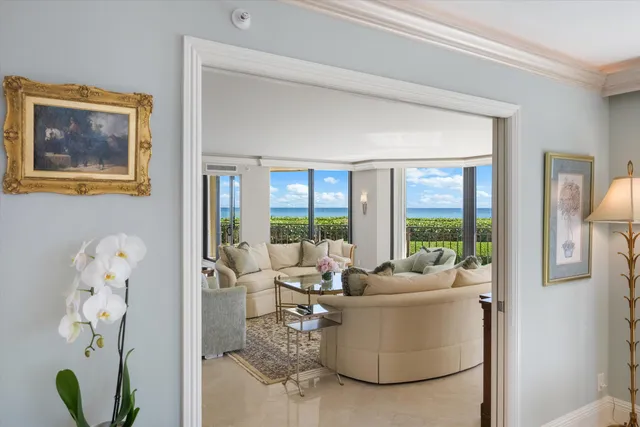 a living room with furniture and a floor to ceiling window