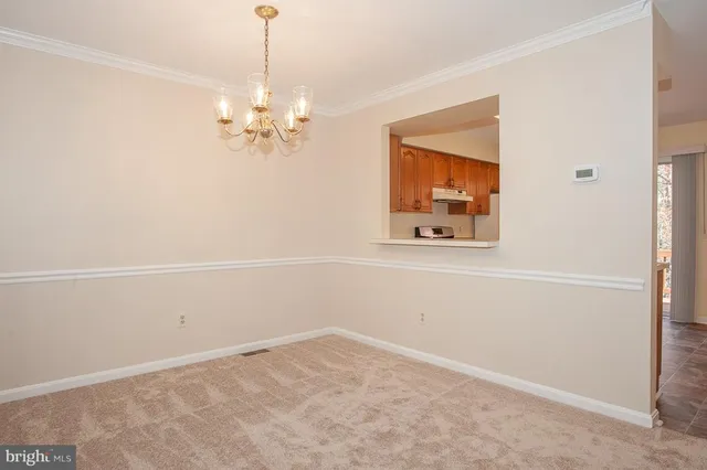 en empty room with windows and fan