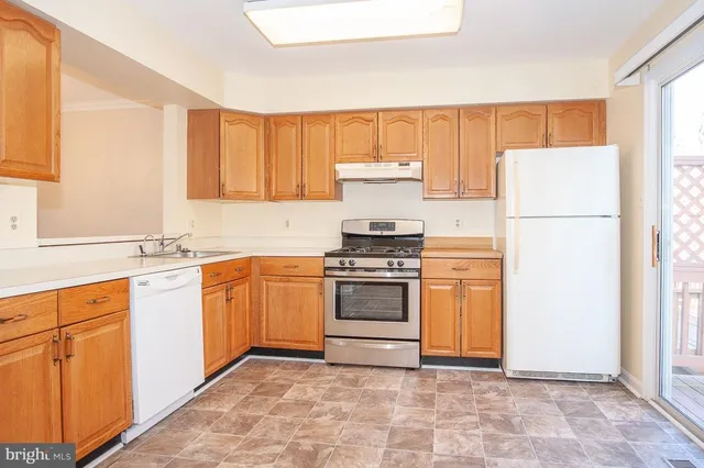 a kitchen with a stove top oven sink and cabinets