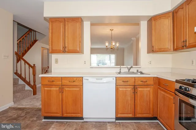 a kitchen with stainless steel appliances granite countertop a refrigerator and a stove