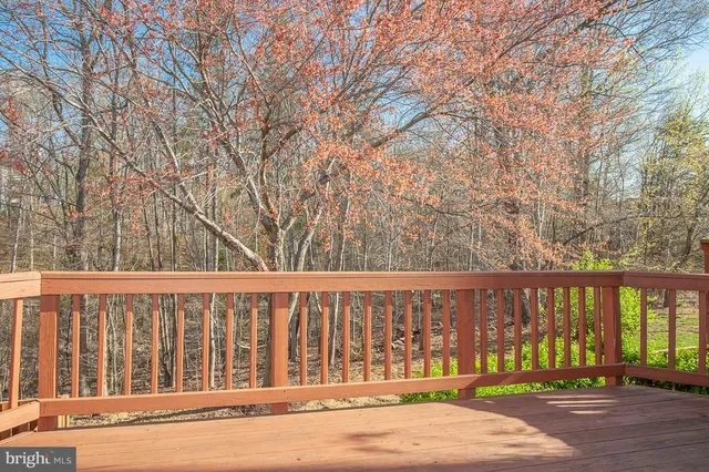 a view of a brick house with large trees