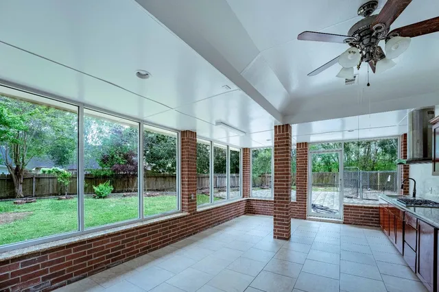 a view of a porch with furniture and garden