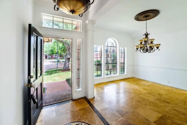 a view of a room with a window and wooden floor