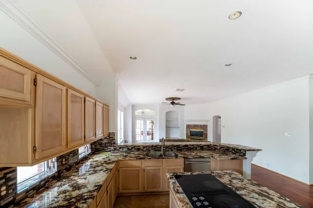 a kitchen with a stove a sink and a refrigerator