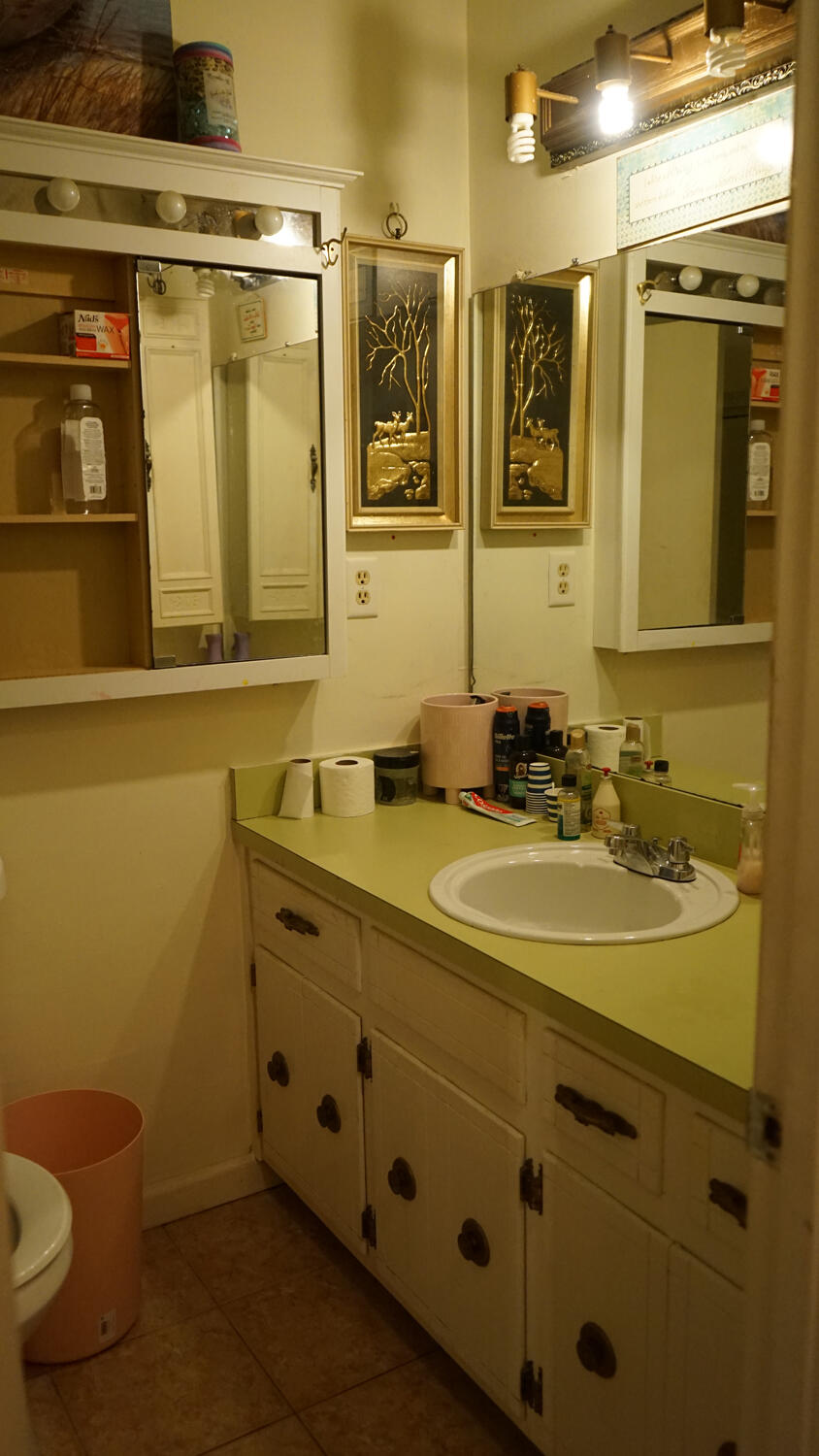 4217 Audiss Road Milton, FL 32583 - Photo 18 of 27 a bathroom with a granite countertop sink a mirror and a toilet