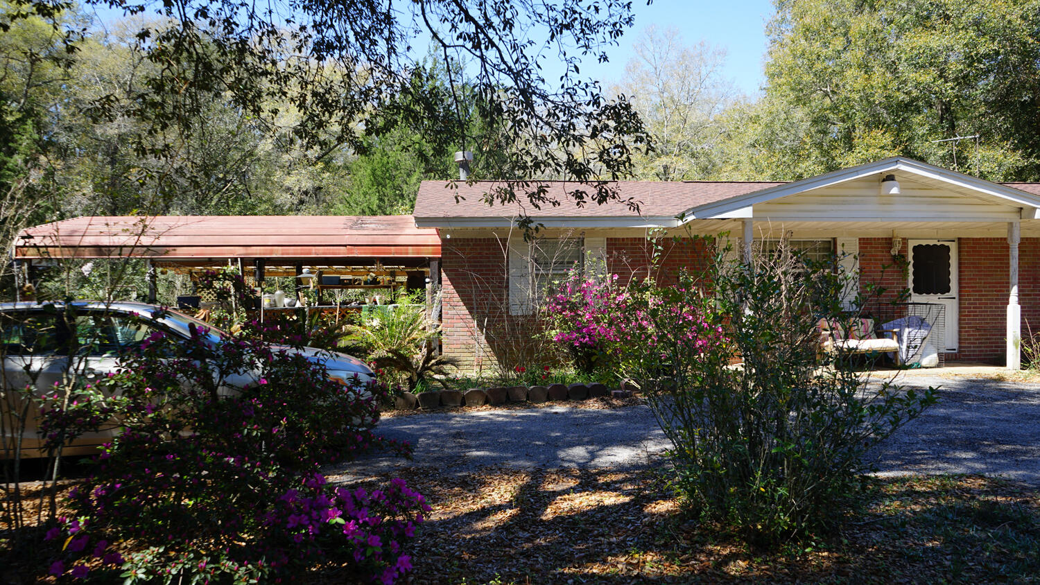 4217 Audiss Road Milton, FL 32583 - Photo 4 of 27 a view of a patio with table and chairs and potted plants