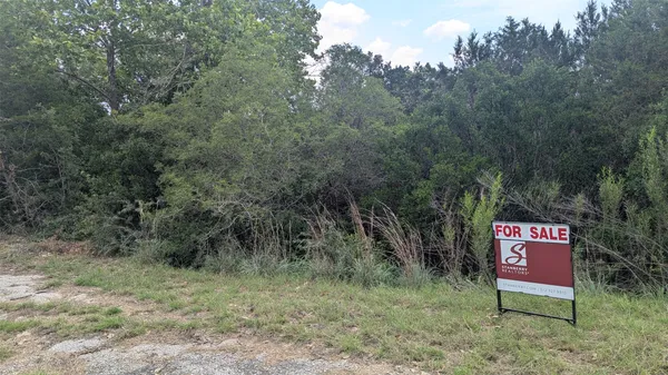 a sign that is sitting in a forest